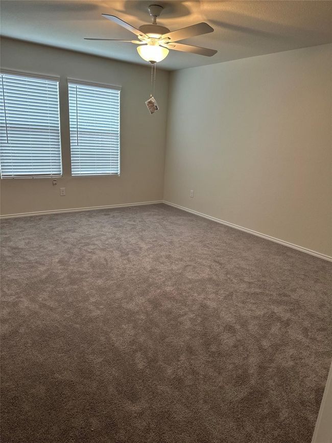Spare room with ceiling fan and carpet floors | Image 8