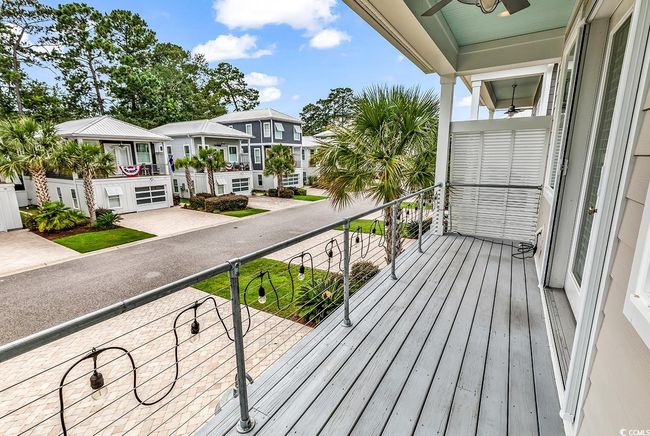 Balcony featuring a residential view and a ceiling fan | Image 30