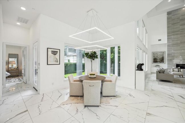 BREAKFAST/MORNING ROOM: Welcome to the serene breakfast nook where mornings are bathed in an abundance of natural light. Large, strategically placed windows frame picturesque views of the surrounding landscape, creating a seamless connection between the indoor and outdoor spaces. This inviting room is perfect for enjoying your morning coffee | Image 13