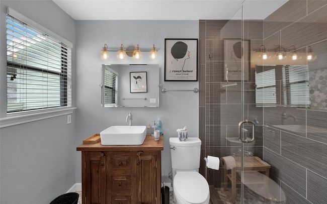 Bathroom with vanity and a stall shower | Image 9