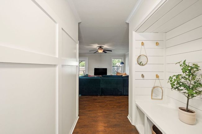 Adorably updated entryway with custom wainscoting paneling & a built-in "mudroom" perfect for storing away shoes, backpacks, coats and more! | Image 4