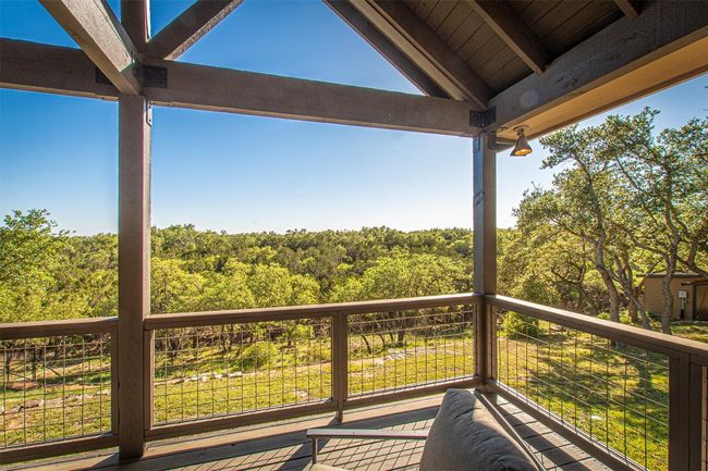 Wooden deck with a view of trees | Image 33