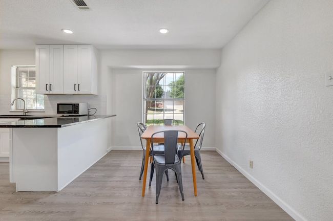 Dining area with baseboards, light wood finished floors, and recessed lighting | Image 10
