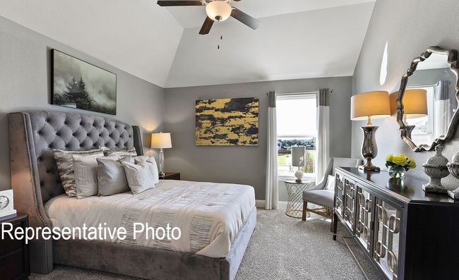Bedroom with carpet flooring, lofted ceiling, and ceiling fan | Image 10