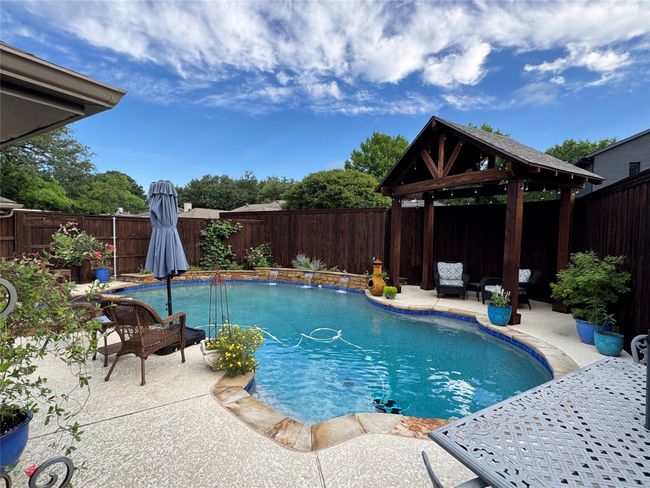 View of swimming pool with a gazebo, a fenced backyard, and a patio area | Image 29