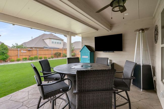 View of patio with ceiling fan and outdoor dining area | Image 20
