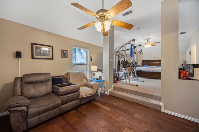 Living room featuring a ceiling fan, wood finished floors, and baseboards | Image 25