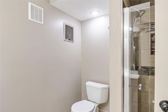 Bathroom with a stall shower and toilet | Image 20