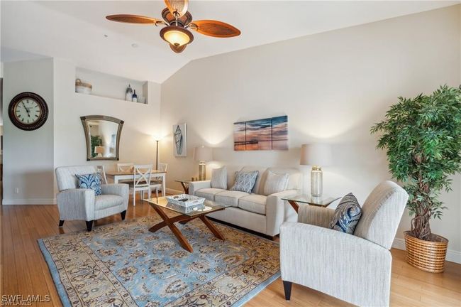 Living room with vaulted ceiling, ceiling fan, and light hardwood / wood-style floors | Image 5