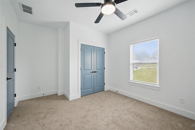 Unfurnished bedroom featuring light colored carpet, baseboards, and visible vents | Image 9