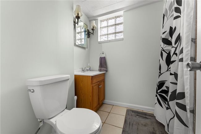 Full bathroom on first lower level, ceramic tile, glass block windows and shower. | Image 10
