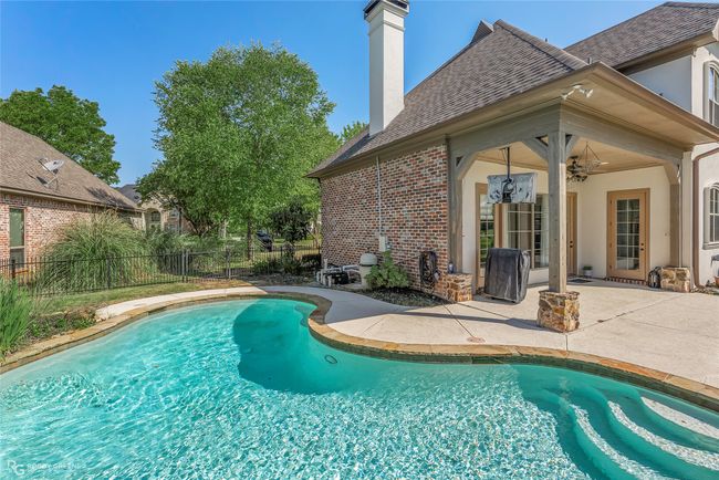 Beautiful pool with water features and a waterfall. | Image 34