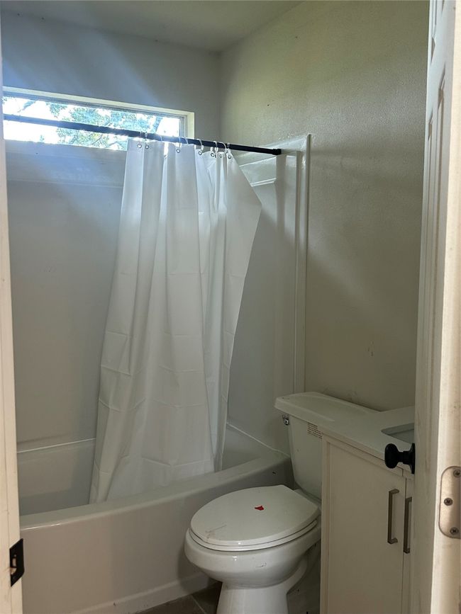Bathroom with shower / tub combo and toilet | Image 21