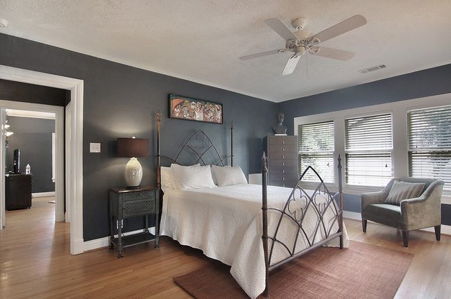 Bedroom featuring wood finished floors, a textured ceiling, baseboards, and visible vents | Image 13