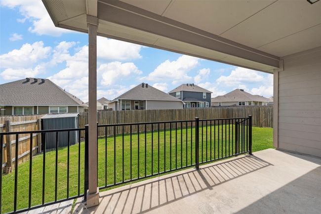 Fenced backyard featuring a residential view, a storage unit, and a patio area | Image 35