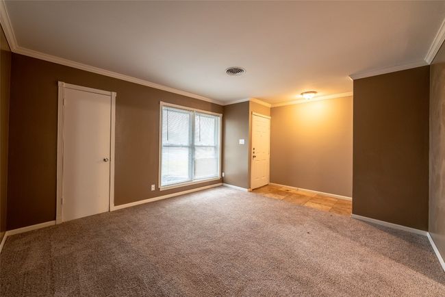Unfurnished room with light colored carpet and ornamental molding | Image 17