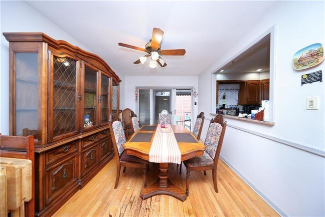 Dining area featuring light wood finished floors and a ceiling fan | Image 8