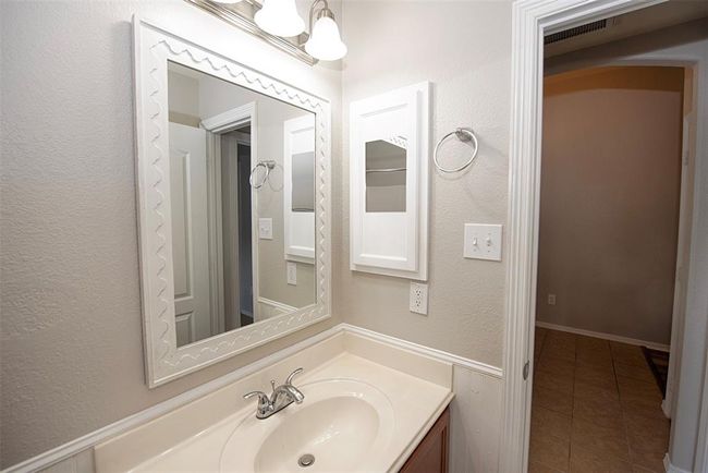 The additional bathroom also features an updated vanity mirror and even a medicine cabinet. | Image 25