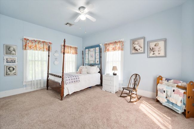 Bedroom with carpet flooring, baseboards, and a ceiling fan | Image 27
