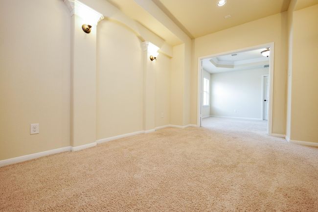 Golden tones in the cinema space open onto naturally lit areas on the 'game room' floor. | Image 19