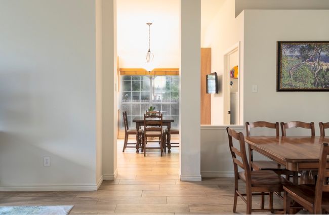 Dining area featuring light wood-style flooring and baseboards | Image 7