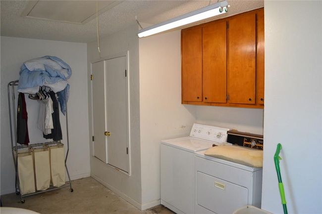 Laundry room with cabinet space and washer and clothes dryer | Image 18