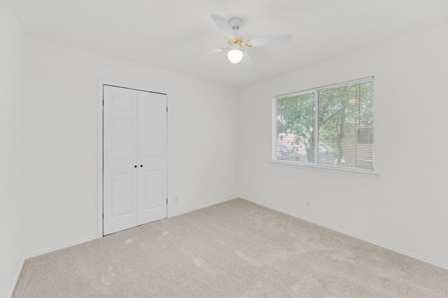 Unfurnished bedroom with a ceiling fan, carpet floors, a closet, and baseboards | Image 30