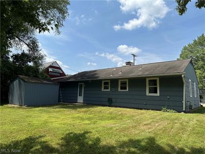 Rear view of house with a yard and a storage unit | Image 3