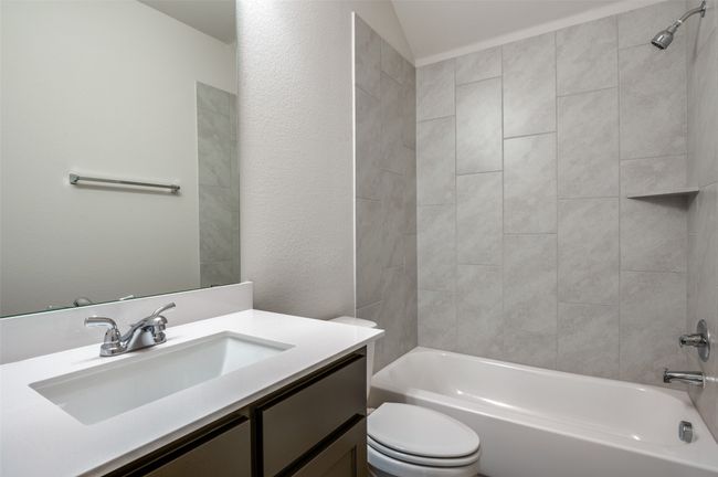 Full bathroom featuring vanity, toilet, and tiled shower / bath | Image 23