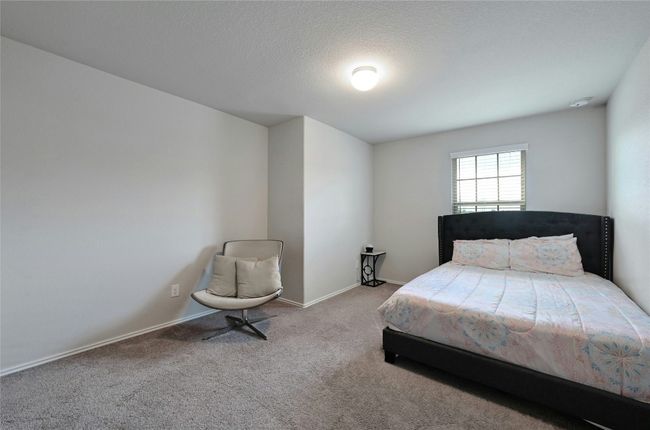 Bedroom featuring carpet floors and a textured ceiling | Image 9