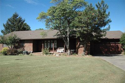 Ranch-style home featuring a front lawn and covered porch | Image 1