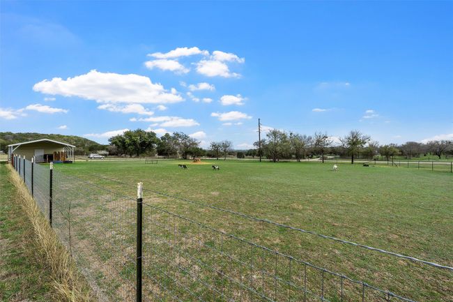 View of yard featuring a rural view, a carport, and fence | Image 32