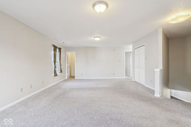 carpeted empty room featuring baseboards and a textured ceiling | Image 50