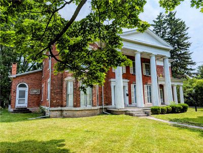 Prominently displayed on Main St in Waterloo, this home has 4, 727 square feet and offers Greek Revivial architecture with touches of Italianate style! | Image 1