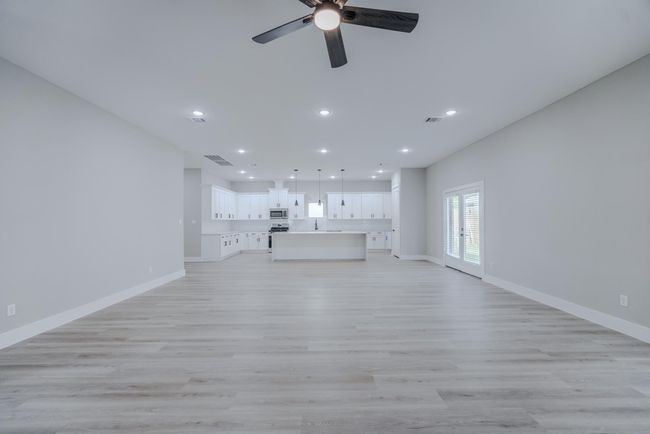 High ceilings and luxury vinyl plank flooring throughout living areas | Image 7