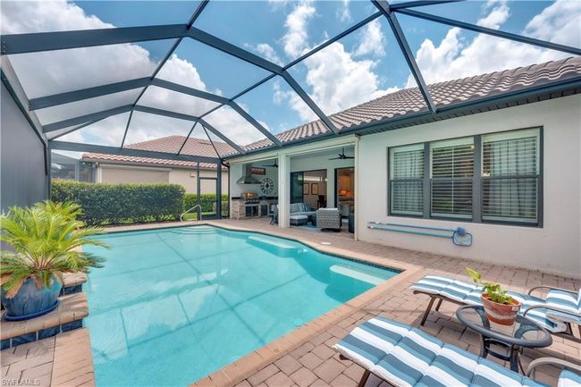 Outdoor pool featuring a patio, ceiling fan, and a lanai | Image 4