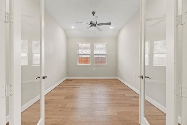 This spacious private study is enclosed with elegant French doors and filled with natural light, making it the perfect setting for remote work, quiet reading, or creative projects. With its versatile layout and serene atmosphere, it can easily flex as a hobby room or library. | Image 6
