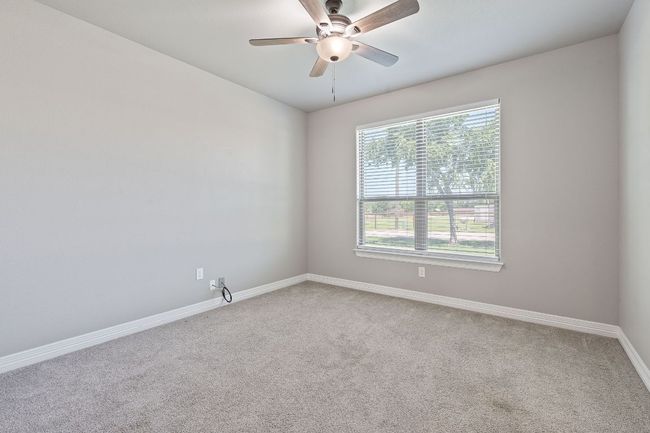 Empty room with carpet floors and a ceiling fan | Image 25