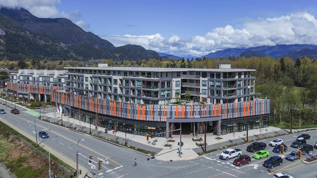 View of building exterior with uncovered parking and a mountain view | Image 26