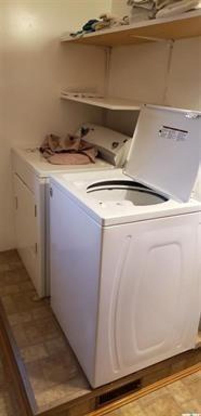 Laundry room with light tile patterned flooring and washer and clothes dryer | Image 15