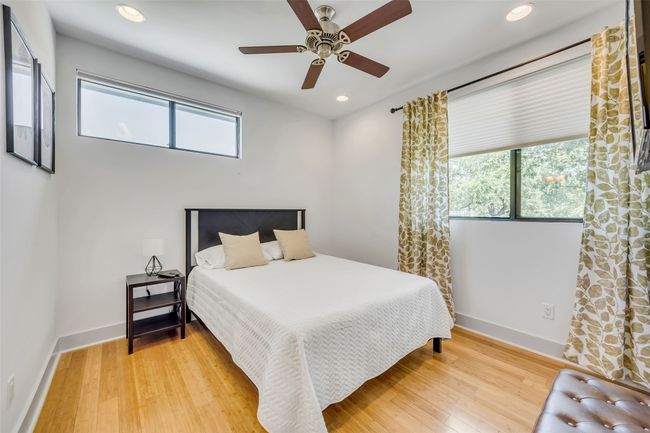 Bedroom with wood-type flooring and ceiling fan | Image 24