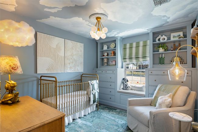 Bedroom featuring a nursery area and a chandelier | Image 32