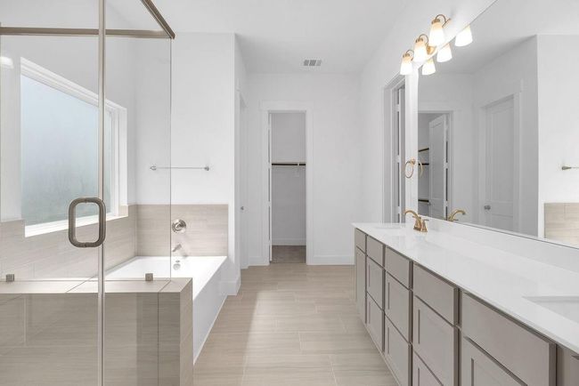 Enjoy the privacy of a well-appointed primary bath in your suite. | Image 12