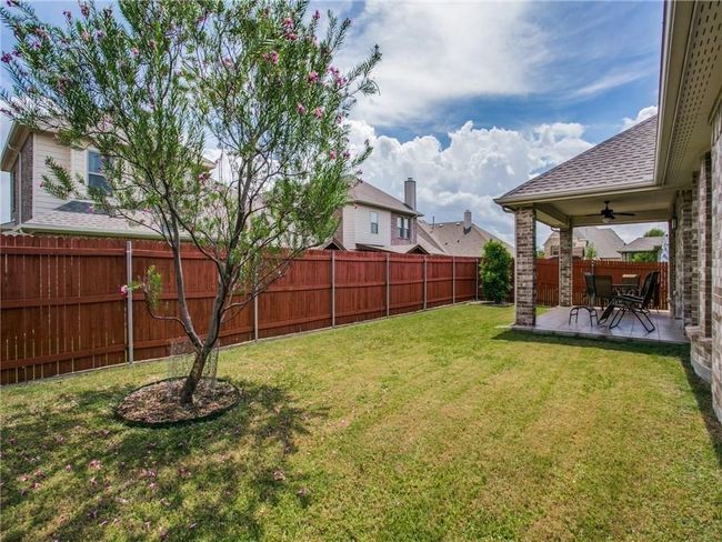 View of yard featuring a ceiling fan and a patio area | Image 22