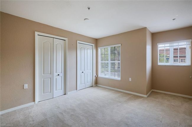 Unfurnished bedroom with two closets and carpet | Image 7