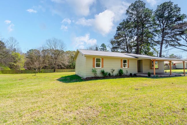View of front of home with an attached carport, a front yard, and fence | Image 5