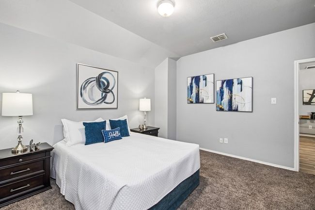 Carpeted bedroom featuring baseboards, vaulted ceiling, and visible vents | Image 33