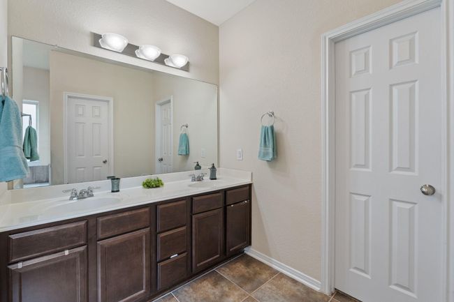 Double sinks and just through door is a large walk-in closet. | Image 22