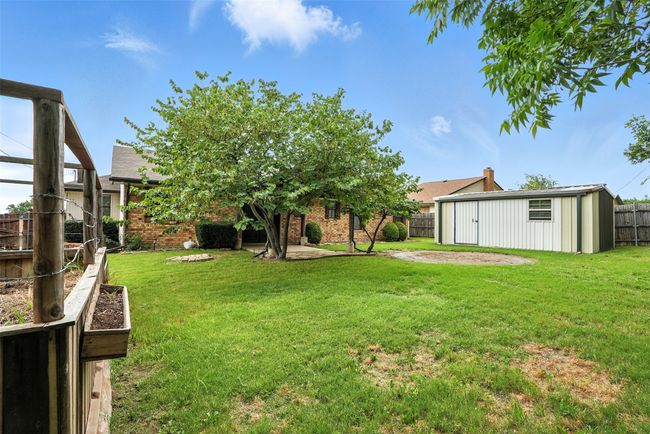 Fenced backyard featuring a shed | Image 23