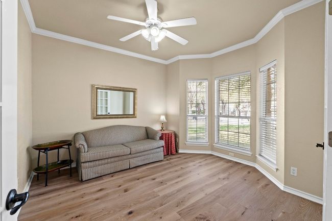 Sitting room featuring a ceiling fan, crown molding, wood finished floors, and baseboards | Image 18